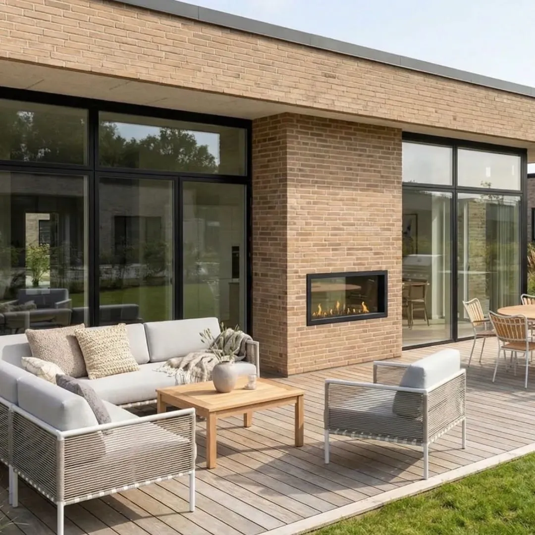 A Decoflame BEV fireplace built into the brick wall of an outdoor terrace
