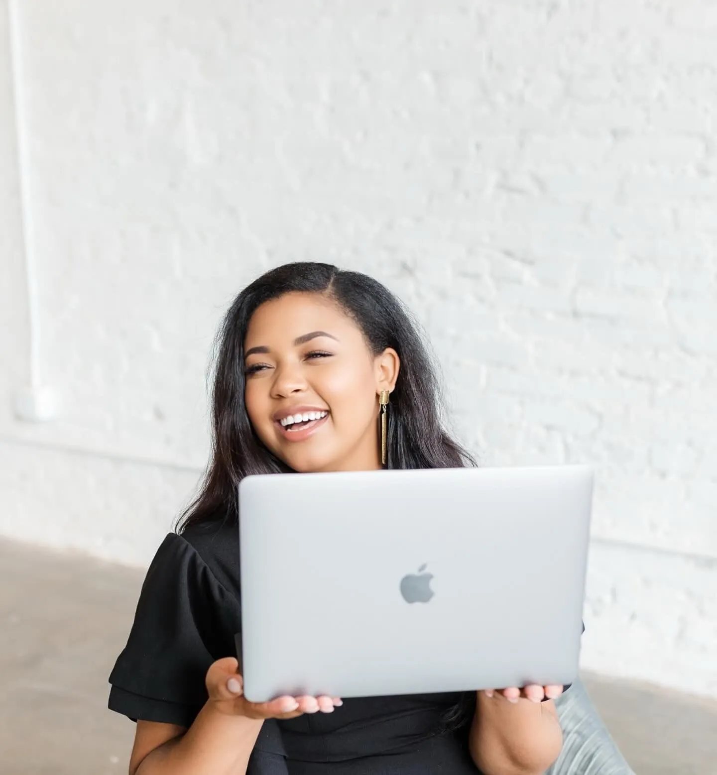 LRC Social founder Lisa Camp laughing while holding a laptop
