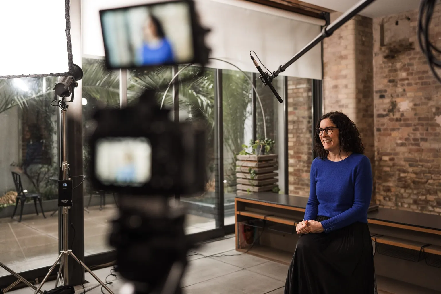 Behind the scenes of an Oh Brother interview shoot with lighting and a boom microphone