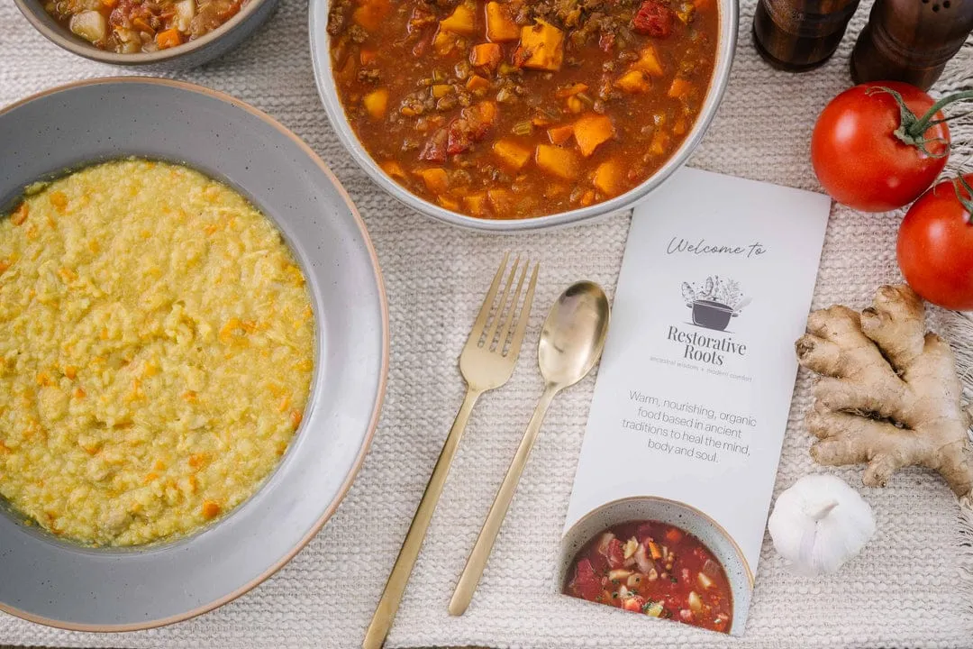 Restorative Roots meals served with a card describing their nourishing ingredients