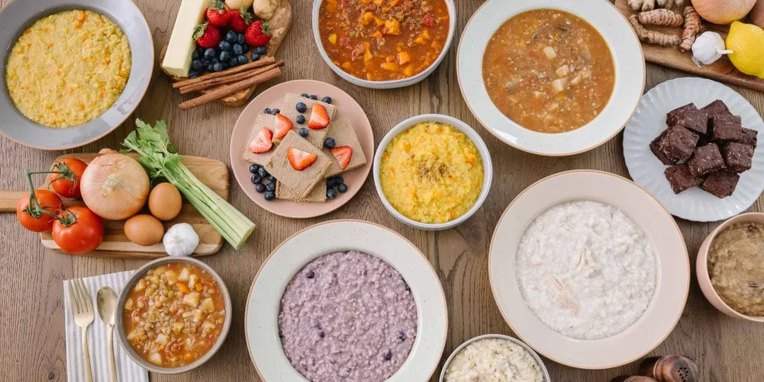A spread of warm postpartum meals from Restorative Roots