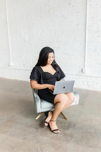 LRC Social founder working on a laptop in a studio chair