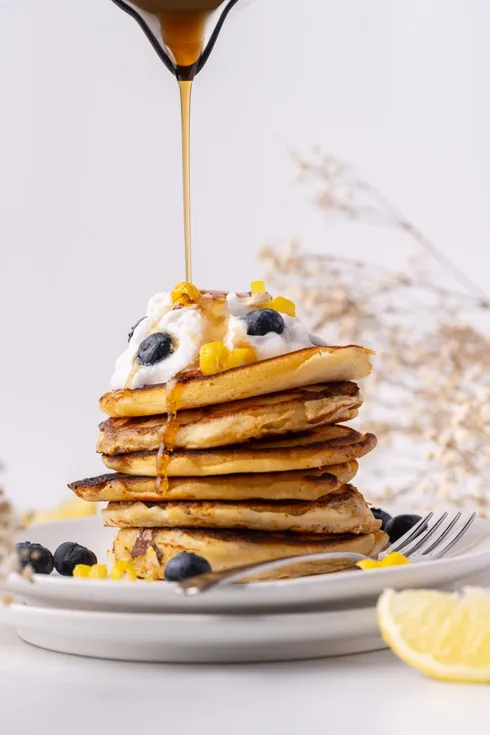 Pancake stack topped with blueberries and syrup from Marley's Menu