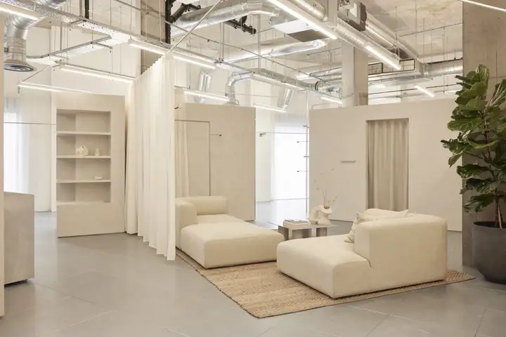 Inside The Fall Bride boutique with soft seating, sheer curtains and plaster fitting rooms