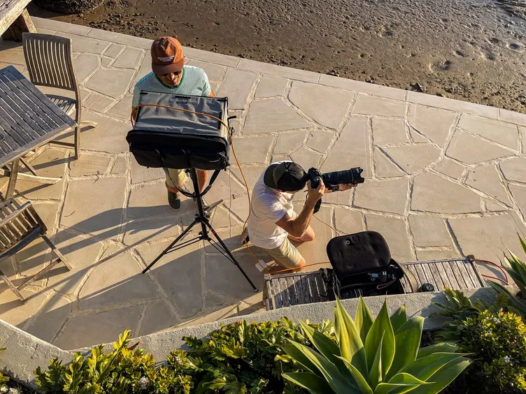 Guy Davies photographing a campaign on a waterfront terrace