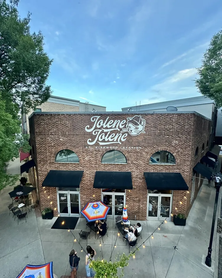 The brick Jolene Jolene building in Kirkwood, Atlanta, seen from above with patio umbrellas out front
