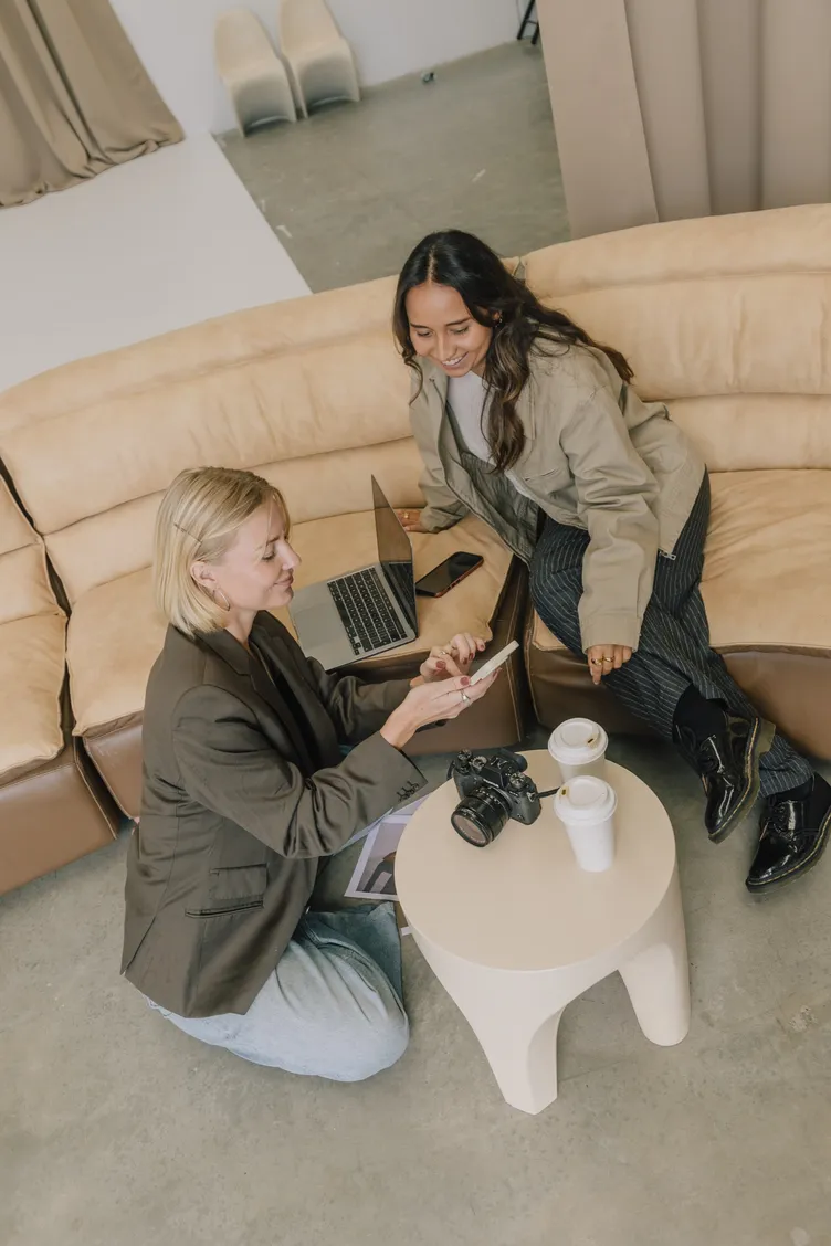 Two Social Fever team members reviewing work together on a phone
