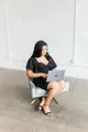 LRC Social founder working on a laptop in a studio chair